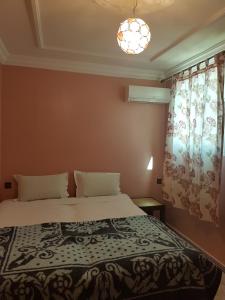 Ένα ή περισσότερα κρεβάτια σε δωμάτιο στο Résidence MARWA