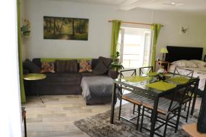 a living room with a couch and a table at Appartement T1 in Dun-les-Places