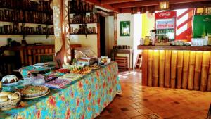 a buffet with food on a table in a restaurant at Aldeia do Bambu Camping e Chalés in Quartéis