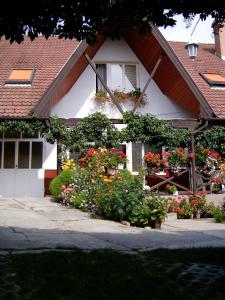 a house with flowers in front of it at Akác Vendégház in Eger