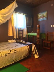 a bedroom with a bed and a table and a window at Homelidays in Ivato