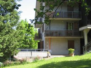a large building with a porch and a balcony at Residence Fontanelle in Sestola