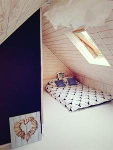 a room with two beds in a attic at Dom z bali w Rycerce Górnej in Rycerka Górna