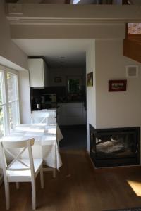 a living room with a table and a fireplace at Casa Terlinden in Brussels