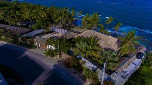 una vista aérea de un complejo con palmeras y el océano en Casa del Mar Lodge Barahona, en Santa Cruz de Barahona