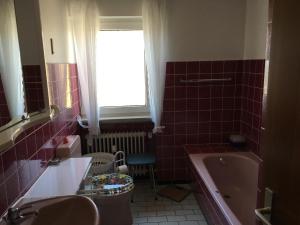 a bathroom with a tub and a toilet and a sink at Ferienwohnungen Hehner in Patersberg +22 photos
