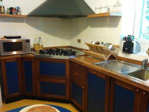 a kitchen with a sink and a stove top oven at Casa Pierini in Civenna