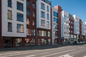 a row of tall buildings on a city street at A.S HOME Kościuszki II in Wrocław