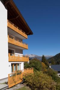 un edificio con balcones de madera en un lateral en Alkira en Sankt Anton am Arlberg