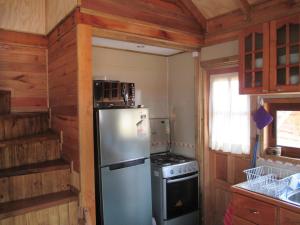 a kitchen with a refrigerator and a stove at Cabañas en Malalcahuello in Malalcahuello