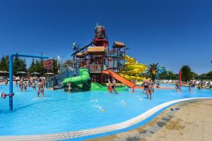 a group of people in a pool at a water park at Holiday Home Vlatka in Lozovac