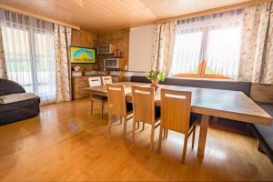 a living room with a dining room table and chairs at Sun Chalet in Schladming