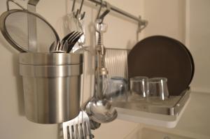 a kitchen utensil rack with utensils on a counter at Palazzo Liguori in Cava deʼ Tirreni