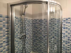 a shower with blue tiles in a bathroom at Garelly 2 in San Vicente de la Barquera +18 photos