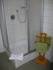 Hotel Gruenshof في فالدورف: حمام مع دش مع باب زجاجي