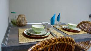 a table with two cups and plates on it at Coast House Moana in Bremerhaven +14 photos
