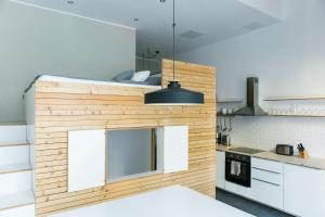 a kitchen with a large wooden wall in a room at Modern Design Apartment in Berlin