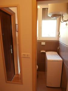 a small bathroom with a toilet and a window at Apartment studio Mia-beach in Split in Split