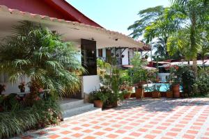 a house with a lot of plants in front of it at Cabañas Las Bifloras in Santa Rosa de Cabal