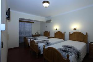 Tempat tidur dalam kamar di Residencial Sra. da Lomba