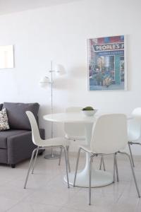 a living room with a white table and chairs at Doñana 414 in Patalavaca