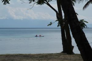 two people in a boat on the water at Peppercorn Beach Resort in Phú Quốc