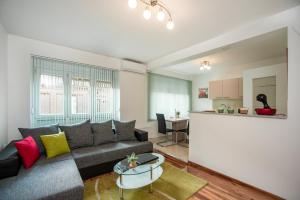 uma sala de estar com um sofá e uma cozinha em Apartment Magic em Zagreb