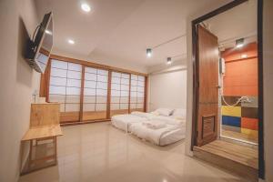 a bedroom with a bed in the middle of a room at Urban-Bamboo in Nakhon Ratchasima