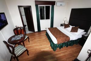 Postel nebo postele na pokoji v ubytování Hotel San Fernando Real