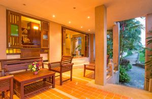 a porch with two benches and a table at Krabi City Seaview Hotel in Krabi