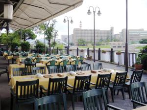 a row of tables and chairs with yellow tables and chairs at Hotel Crown Palais Kokura in Kitakyushu +21 photos
