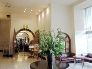 a lobby with a vase of flowers on a table at Hotel Crown Palais Kokura in Kitakyushu