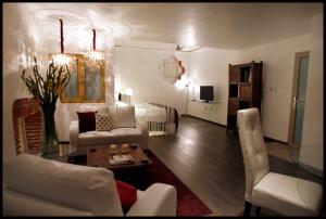 a living room with white furniture and a bedroom at El Sueño Hotel & Spa in Puebla