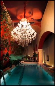a large chandelier is hanging over a swimming pool at El Sueño Hotel & Spa in Puebla