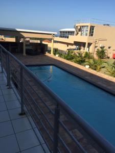 a swimming pool on the balcony of a building at The Norwegian Lodge in Umkomaas