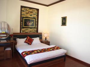 Postel nebo postele na pokoji v ubytování Villa Du lịch HUY HOÀNG