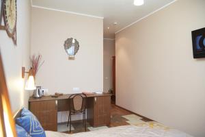 a bedroom with a desk and a chair in a room at Hotel Anzas in Abakan