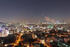 a view of a city at night with buildings at Hotel The Designers Hongdae in Seoul
