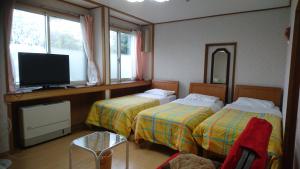 Postel nebo postele na pokoji v ubytování Inn Yamanami