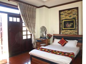 Postel nebo postele na pokoji v ubytování Villa Du lịch HUY HOÀNG