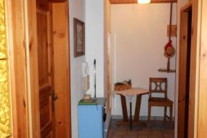 a small kitchen with a table and a small refrigerator at Leitingerhof in Thalgau