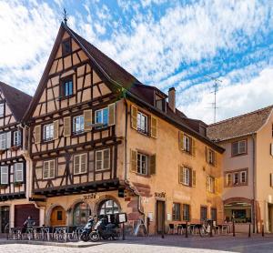 a large building with motorcycles parked in front of it at La Venise bleue in Colmar
