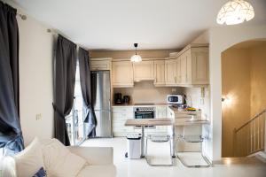 - une cuisine avec des placards blancs, une table et des chaises dans l'établissement Duplex 2bedroom for you, à Palm-mar