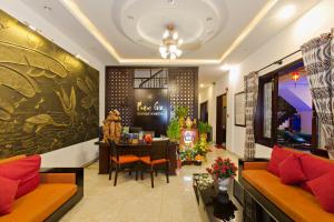 a living room with a couch and a table at Pham Gia Boutique Villa in Hoi An