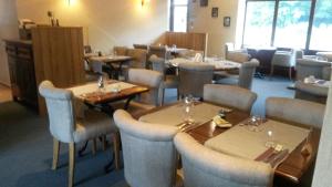 a restaurant with tables and chairs in a room at HOTEL RESTAURANT La CREPERIE Du CHATEAU in Craon +21 photos