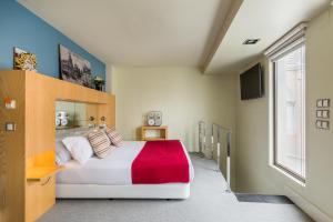 a bedroom with a large bed and a window at Room Mate Alicia, Madrid in Madrid