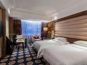 Voodi või voodid majutusasutuse Guangzhou Good International Hotel toas