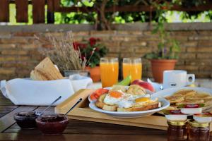 a table with a plate of breakfast foods and drinks at Archontiko Nikolopoulou in Vitina