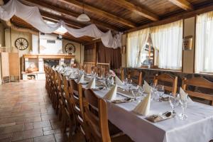 a long dining room with a long table and chairs at Tokaj Zlatá Putňa - Restaurant & Pension in Viničky