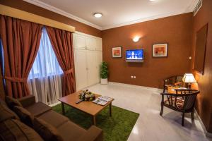 a living room with a couch and a table at Welcome Hotel Apartments 1 in Dubai